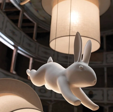 Lampada a sospensione di design dove da un cappello di tessuto esce un coniglietto di ceramica Wow di Karman